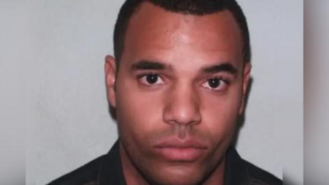 A close-up head-and-shoulders image of a Emem Udaw looking directly at the camera, with short dark hair with a plain light-coloured background.