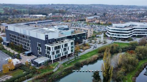 A drone shot of the University campus on the river. 