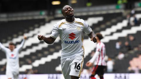 Aaron Nemane celebrating his goal for MK Dons against Cheltenham Town
