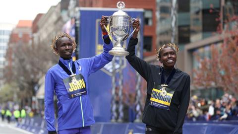  John Korir and Sharon Lokedi hold up the Boston Marathon trophy