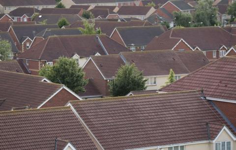 A view of tiled house roofs stretching off into the distance