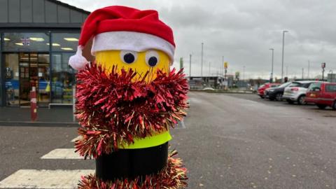 A picture of the bollard in the Lidl car park in Netherfield, complete with festive adornments.