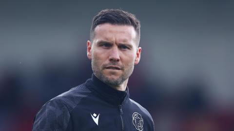 Walsall boss Mat Sadler looks on,