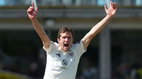 Will Williams with both hands aloft appealing for a wicket for Glocuestershire