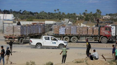 Trucks loaded with humanitarian aid supplies arrive Gaza through the Kissufim Border Crossing following the ceasefire agreement