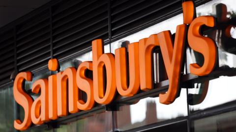 A close up of a Sainsbury's sign on one of its shops