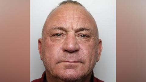 A police mugshot of Michael Tyrrell. He is 55, balding and has brown eyes.