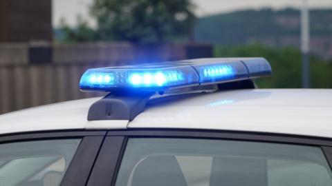 A stock image of a police car with blue lights