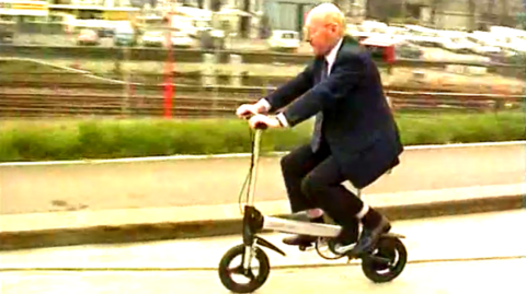 Sir Clive Sinclair riding the Sinclair Zike