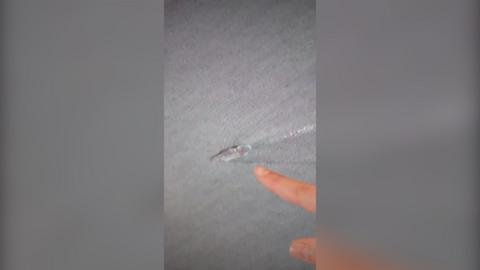 Finger pointing at image of carrier