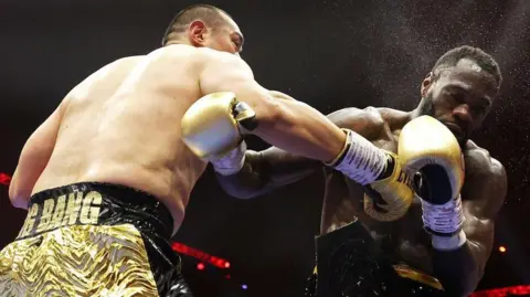 Zhilei Zhang punches Deontay Wilder in the face