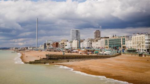 Brighton seafront from the pier, looking out towards the i360 and the promenade.