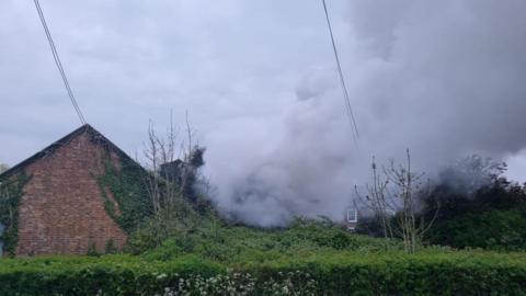 smoke coming from a barn