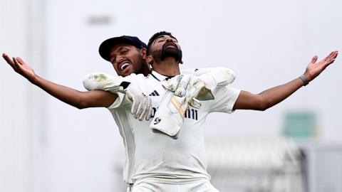 Mohammed Siraj stands with arms spread wide in celebration after taking the final wicket in the fifth Test against England