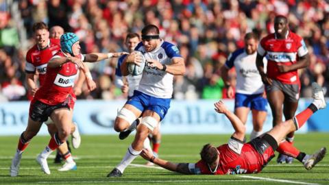 Josh Bayliss barges through a tackle with the ball