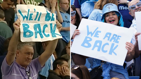 John Mullaney holding up a "We'll be back" sign, next to him a fan is holding up a "We are back" sign