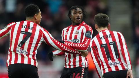 Romaine Mundle (centre) celebrates his goal with team-mates