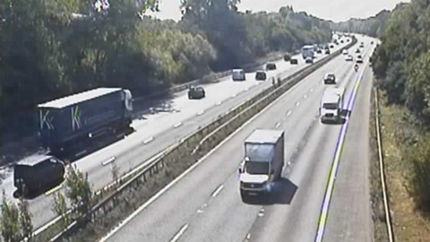 Cars driving along the M4, with traffic travelling on both sides.