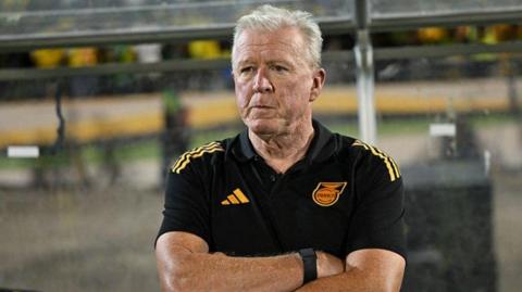 Steve McClaren stands with his arms folded
