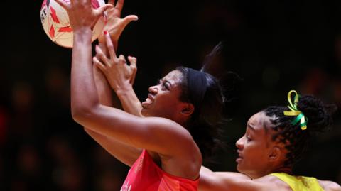 England's Liv Tchine and Jamaica's Shamera Sterling Humphrey go for the ball