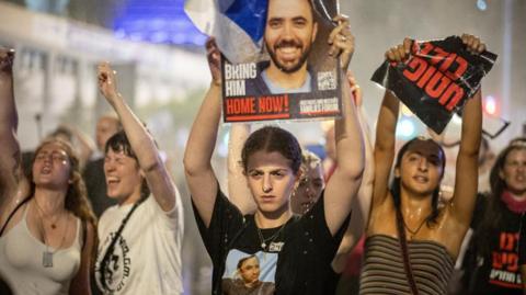 Demonstrators hold posters as Israeli police deploy a water cannon, at a demonstration against Prime Minister Benjamin Netanyahu's government and a call for the release of hostages in Gaza, amid the Israel-Hamas conflict, in Tel Aviv, Israel, June 8, 2024