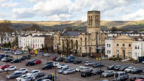 View of a church and car park in Cheltenham from above