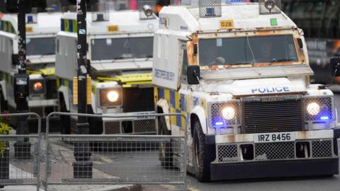 Police land rovers in a line 