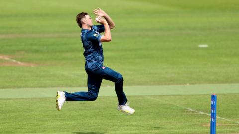 Gus Miller of Northamptonshire bowls during a Metro Bank One Day Cup match