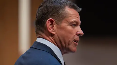 A side-on shot of Rhun ap Iorwerth addressing the Senedd