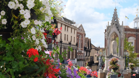An image of Maidstone Town Centre. A floral display can be seen in the foreground of the image.
