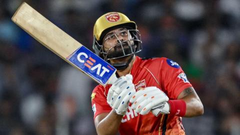 Punjab Kings batter Shreyas Iyer watches the ball after playing a shot in an IPL match against Mumbai Indians