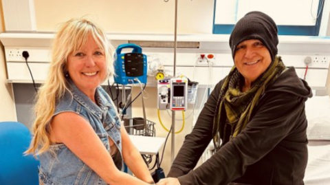 Mike Peters sits on hospital beds with his wife Jules