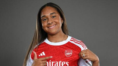 Olivia in an Arsenal shirt.