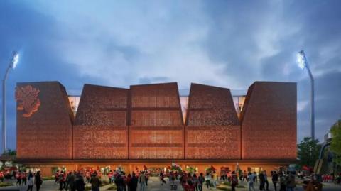 Dyma gynllun rhithiol o'r cynllun ar gyfer y Kop, eisteddle newydd y Stok Cae Ras. Mae'n adeilad mawr gyda 5 panel a'r ddraig goch i'w gweld ar ochr chwith y stadiwm. Mae cefnogwyr yn chwifio baneri y tu allan i'r stadiwm newydd.