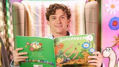 Tom Holland reading Superworm on the CBeebies set