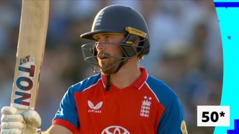 Phil Salt holding up his bat after playing in the men's international T20.