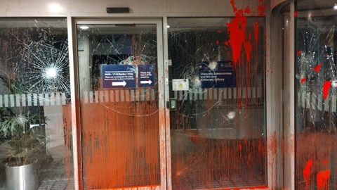 A glass entrance to Wellington Square offices, which have been badly damaged. Damage that looks like spider webs has been left on the windows