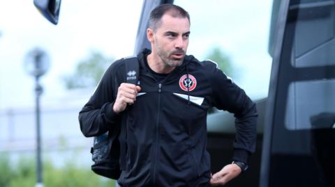 Ruben Selles emerging from the Sheffield United team bus during their friendly with York City
