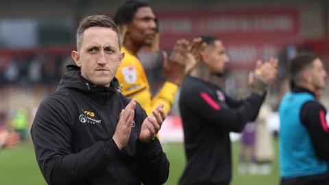 Dafydd Williams and players applaud fans 
