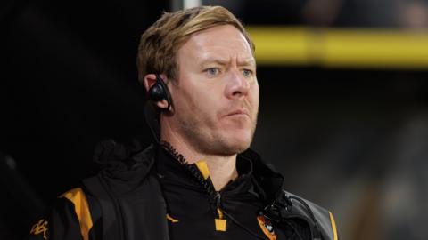 Hull City assistant manager Dean Holden on the sideline wearing an earpiece