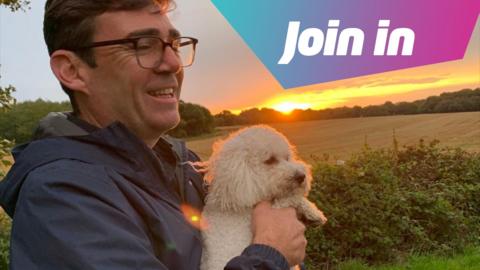 Andy Burnham holding Axel the white Bichon-Poo