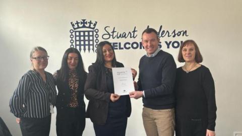 Leanne McDonald receives her award from MP Stuart Anderson