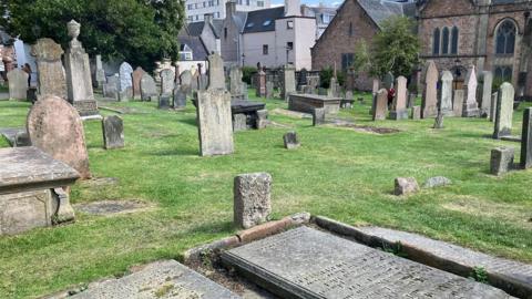 A view across gravestones and other grave markers at Old High Church in Inverness.
