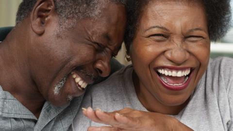 Close up of a middle-aged couple laughing