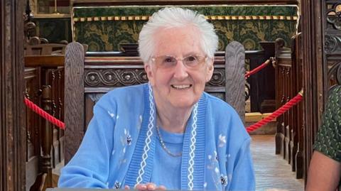 Lucille Terry smiling in a church