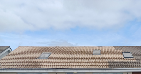 A photo of a roof which has been partially cleaned