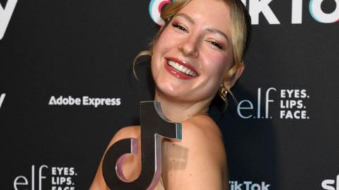 Maddi Neye-Swift smiles and poses with her TikTok award