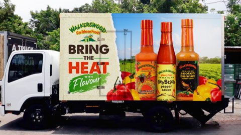 A lorry in Jamaica advertising hot sauces from local brand Walkerswood on the side of the vehicle