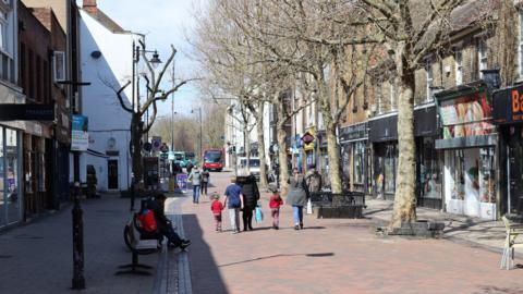 Shoppers walking down a pedestrianised shopping street in Gillingham in Kent