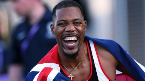 Zharnel Hughes celebrates winning the British men's 100m title